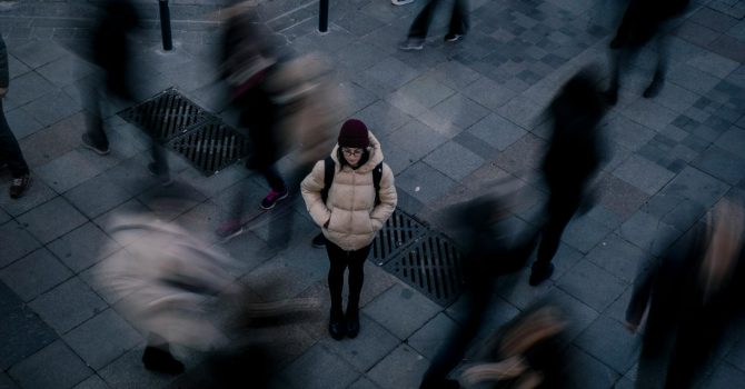 Woman Standing Alone In Crowd